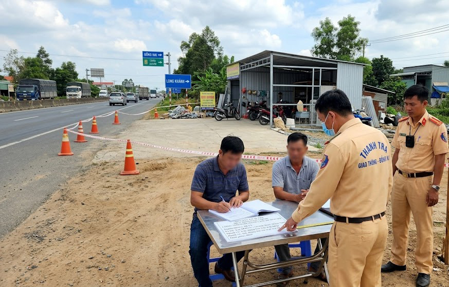 Biên bản kiểm tra hiện trạng công trình vi phạm hành lang đường bộ QL1A tại huyện Trảng Bom Đồng Nai do lực lượng thanh tra giao thông lập, ảnh chụp thực tế 2025 